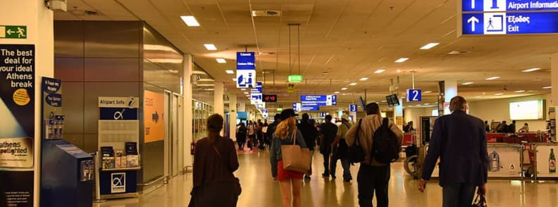 aeroport athenes arrivees transport centre ville guide Comment aller à Athènes depuis l’aéroport. Hall des arrivées de l’aéroport international d’Athènes avec voyageurs marchant vers la sortie et panneaux indiquant métro, bus et taxis vers le centre-ville.