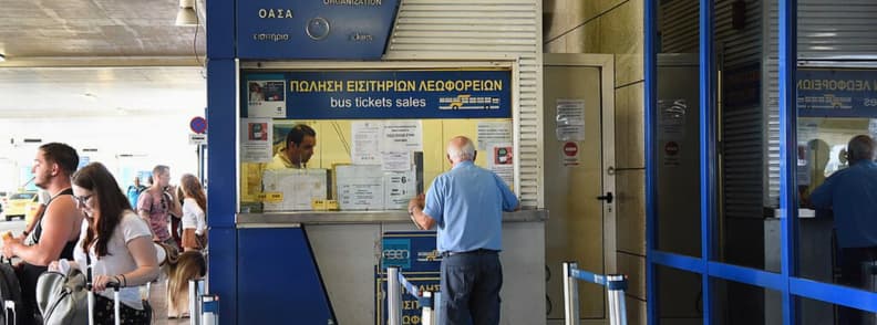 billet bus aeroport athenes x95 x96 guichet officiel Guichet officiel de vente de billets de bus à l’aéroport international d’Athènes avec panneau bus tickets sales et voyageurs achetant un ticket pour le bus X95 ou X96.