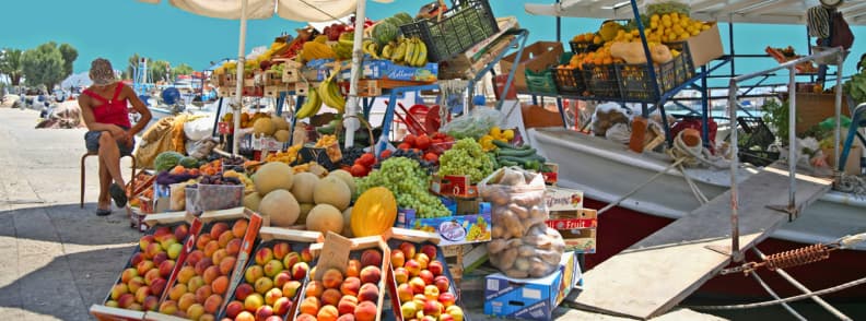 Tarabă cu fructe și produse locale în portul din Egina Grecia, inclusiv fistic Egina și alte alimente proaspete