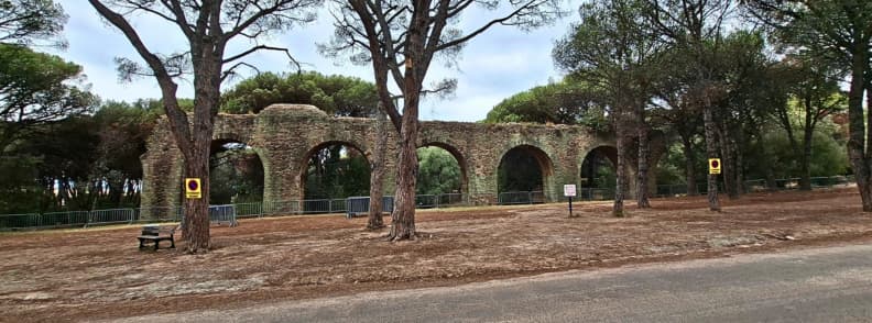 Vestigiile apeductului roman din Fréjus, cu arcade antice din piatră, înconjurate de pini înalți în Parc Aurélien, lângă Villa Aurélienne.