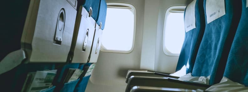 Premium Economy Sleep Comfort Upgrades and Sleep Tips for Long Flights Empty premium economy class seats with extra legroom, illustrating premium economy sleep benefits such as wider seats, greater recline, and quieter cabins for better rest.