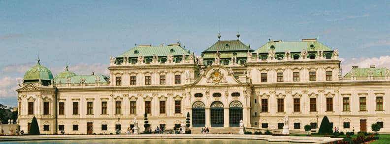 belvedere palace vienna upper gallery exterior view Front view of Upper Belvedere Palace in Vienna with baroque façade, green roof domes, and reflecting pool