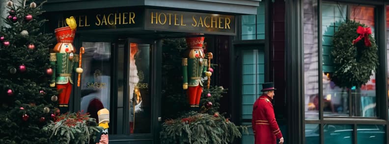 hotel sacher vienna christmas decorations entrance view Hotel Sacher entrance in Vienna decorated for Christmas with nutcrackers, wreaths, and festive trees during winter