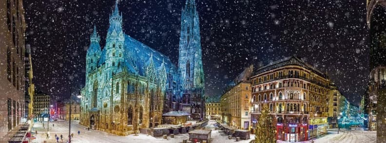 winter weekend in vienna st stephens cathedral vienna snow winter night lights St Stephen’s Cathedral in Vienna illuminated at night with snow falling and surrounding streets covered in fresh winter snow