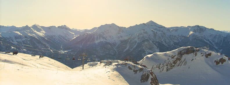 Serre Chevalier Ski Resort Panorama Guide Wide winter panorama of Serre Chevalier with snowy ridges, chairlifts, and sunlit Alpine peaks.
