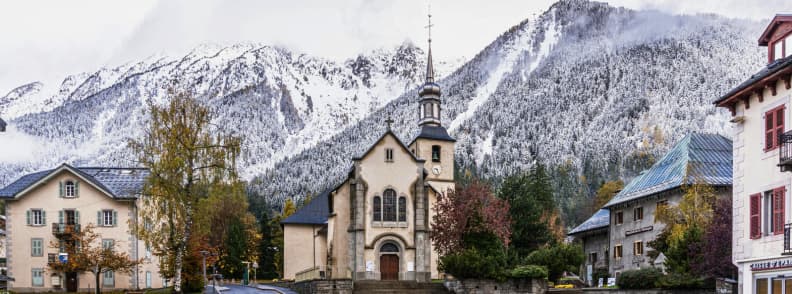 Skiing in France Chamonix Alpine Village Chamonix village with its historic church framed by early snow on the surrounding Alpine peaks.