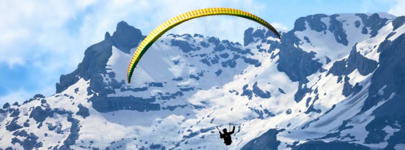 Skiing in France Paragliding Chamonix Alps Adventure Paragliding over the snowy peaks of Chamonix with wide Alpine views toward Mont Blanc.