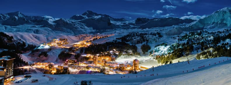 Skiing in France accommodation La Plagne Nightscape Paradiski Paradiski accommodation. La Plagne illuminated at night with glowing ski villages surrounded by snowy mountains in the Paradiski area.