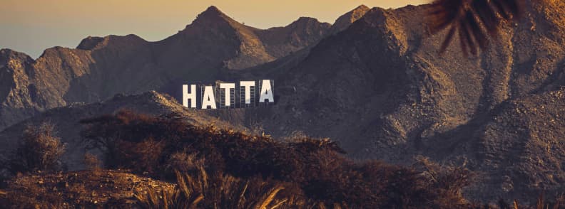 Hatta Sign hike best sunrise and sunset viewpoint in Hatta UAE things to do in Hatta: hike to Hatta Sign, a landmark on the mountains at sunset in Hatta UAE
