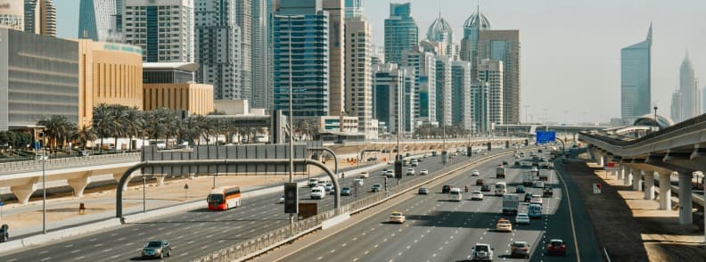 Dubai to Abu Dhabi bus cheap transport option View of Dubai highway with buses and cars heading towards Abu Dhabi