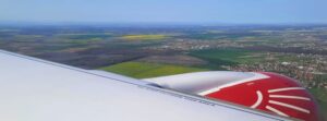 View over Romania during descent on Animawings Airbus A220-300 flight from Nice to Bucharest, with engine and wing visible