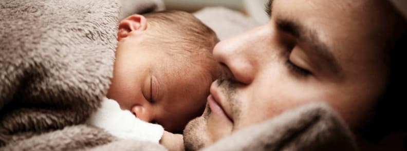 Baby Sleep Travel Resting Together in Transit Father and newborn baby sleeping together under a blanket. A peaceful moment reflecting baby sleep travel and emotional rest