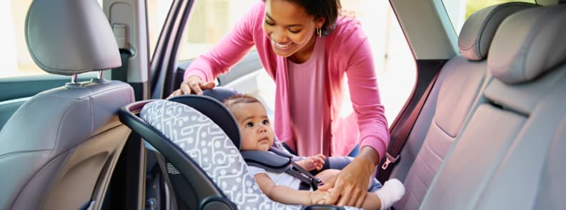 Road Trip Baby Setup Safe and Smiling in the Back Seat Mother securing baby into travel car seat before hitting the road, a key moment in any well-planned road trip baby journey