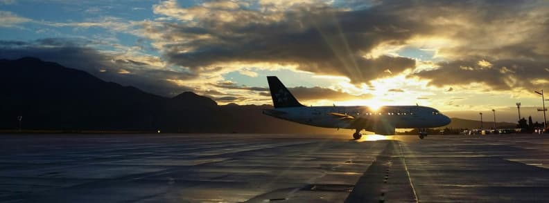 flight selection and timing for flying with toddlers Commercial airplane on the runway at sunrise, illustrating flight selection and timing strategies when flying with toddlers