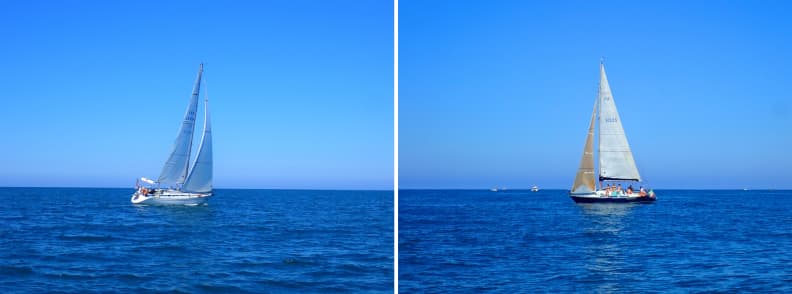 Tuscan coast sailing itinerary Italy Two sailboats under full sail on the Tuscan coast sailing itinerary Italy, captured in open water on a calm summer day between Viareggio and Pisa.
