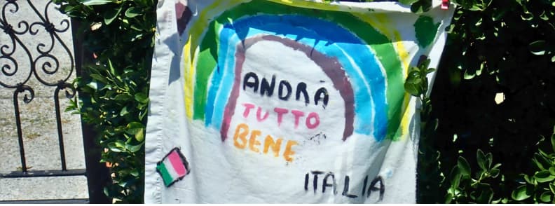 andra tutto bene message Hand-painted rainbow flag with the words andrà tutto bene seen in Tuscany during Italy COVID-19 travel 2020, symbolising hope and solidarity during pandemic sailing in Italy.