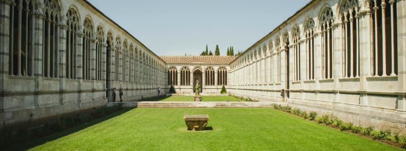 camposanto monumentale Interior courtyard of Camposanto Monumentale in Pisa with marble arcades and manicured grass