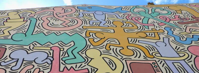 keith haring tuttomondo mural Close-up of Keith Haring Tuttomondo mural in Pisa showing colourful dancing figures and bold outlines
