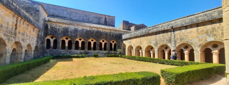 Cloister Garden of Abbaye du Thoronet Photography Highlights Provence Sunlit cloister garden of Abbaye du Thoronet in Provence with Romanesque arcades and neatly trimmed hedges