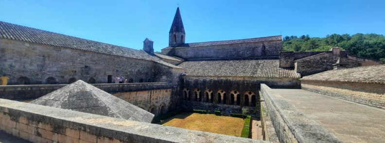Cloister Terrace at Abbaye du Thoronet Elevated View of Cistercian Masterpiece Elevated view from the cloister terrace of Abbaye du Thoronet showing the central garden, arcaded galleries, and bell tower in Provence