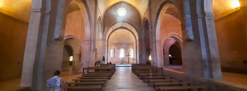 Nave of the Church at Abbaye du Thoronet Cistercian Heritage Provence Interior nave of the church at Abbaye du Thoronet in Provence with vaulted arches, stone columns, and wooden benches