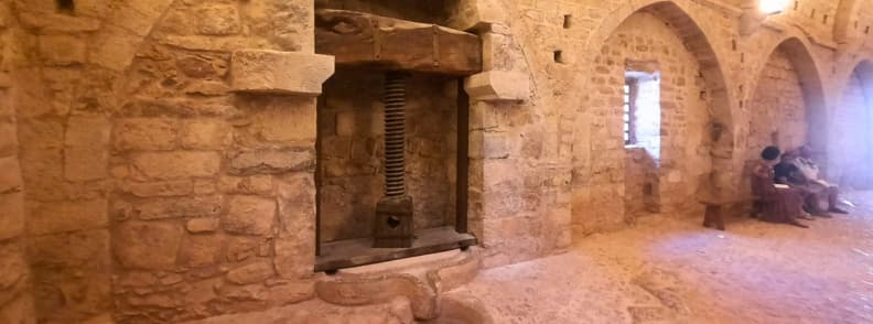 Olive Oil Press at Le Thoronet Abbey Cellar Cistercian Monastery Provence Historic olive oil press inside Abbaye du Thoronet in Provence, built into the stone wall of the medieval Cistercian monastery