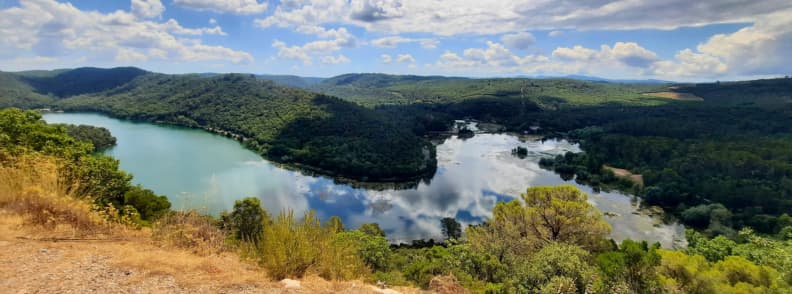 Panoramic View of Lac de Carces from the Upper Loop Trail Panoramic view of Lac de Carcès surrounded by forested hills seen from the upper hiking trail in Provence Verte