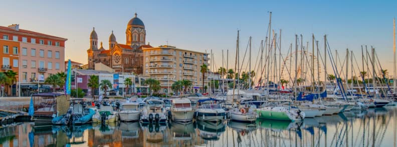 Saint Raphael marina old port French Riviera sunset Boats moored in the Saint-Raphaël marina with the basilica rising behind at golden hour on the French Riviera