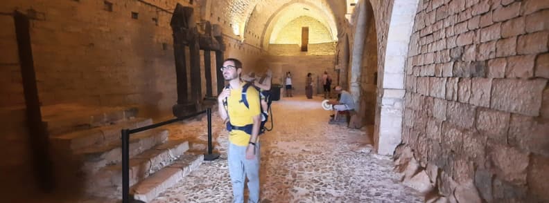 Visiting Abbaye du Thoronet with Children Family Friendly Tips Provence Father carrying a toddler in a baby carrier while visiting the interior of Abbaye du Thoronet in Provence