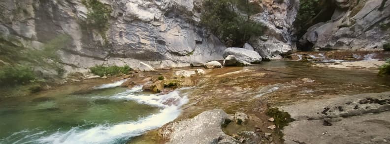 Gorges de la Siagne hike river view Provence trail Clear river flowing between rocky cliffs on the Gorges de la Siagne hike near Saint Cezaire