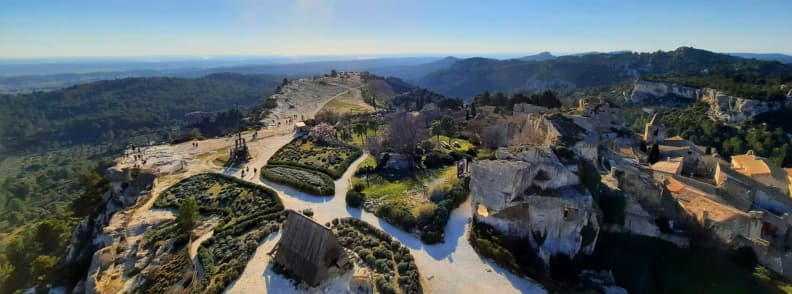 Panoramic view from the terrace of Château des Baux-de-Provence overlooking the Alpilles hills and medieval village ruins