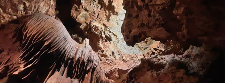 Saint Cezaire cave draperies limestone formations Provence Visit Saint-Cézaire Cave. Large limestone draperies and rock textures inside Saint Cezaire cave illuminated during a guided tour