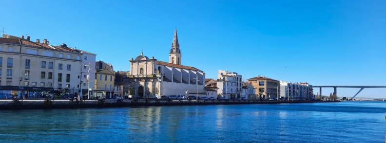 Canal Galiffet Eglise Saint Genest Martigues Etang de Berre Provence View of Canal Galiffet and Église Saint-Genest, with the Martigues waterfront along the Étang de Berre under a bright blue Provençal sky.