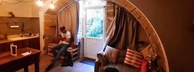 La Chaumiere BedinShop Romans sur Isere apartment interior cozy living area of La Chaumiere BedinShop apartment in Romans sur Isere with stone arch and natural light