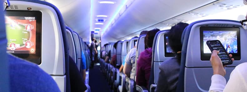 Passengers seated inside a low cost airline cabin on a winter flight in Europe