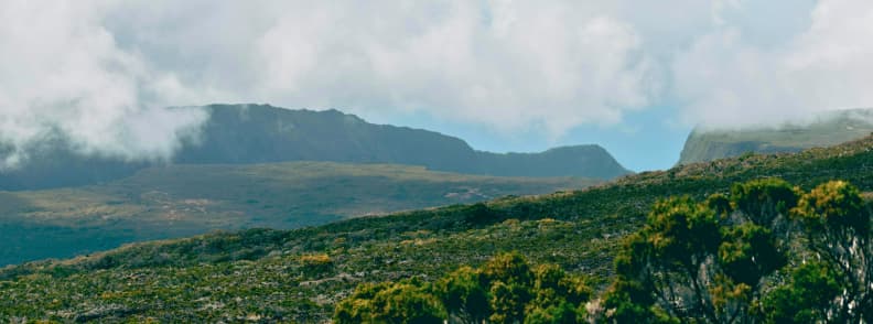 Mountain plateau and coastal landscape on Réunion Island under changing cloud cover