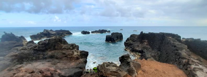 Volcanic rock formations and natural ocean pool at Manapany Bay on the south coast of Réunion Island