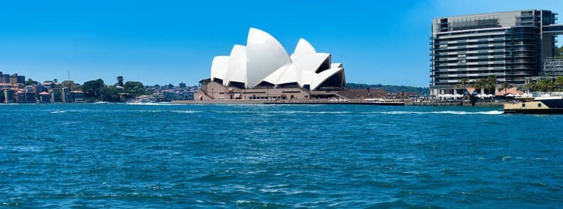 Sydney Opera House viewed from Sydney Harbour with city skyline in Australia