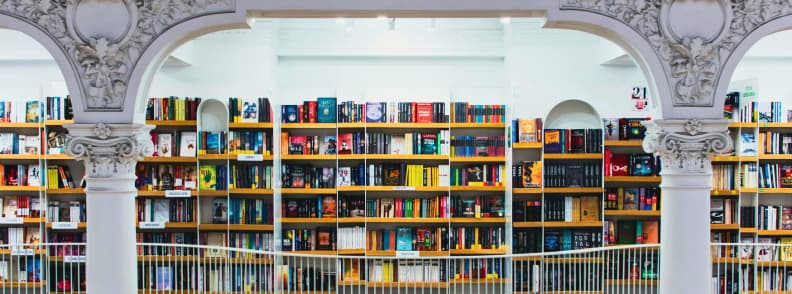 Bucharest at night without partying inside Cărturești Carusel bookstore, bright interior with bookshelves and ornate architecture in Old Town