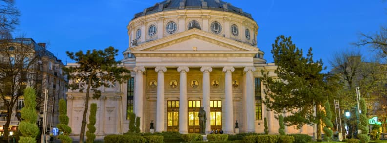 Bucharest at night without partying at the Romanian Athenaeum, illuminated historic concert hall on Calea Victoriei in the evening