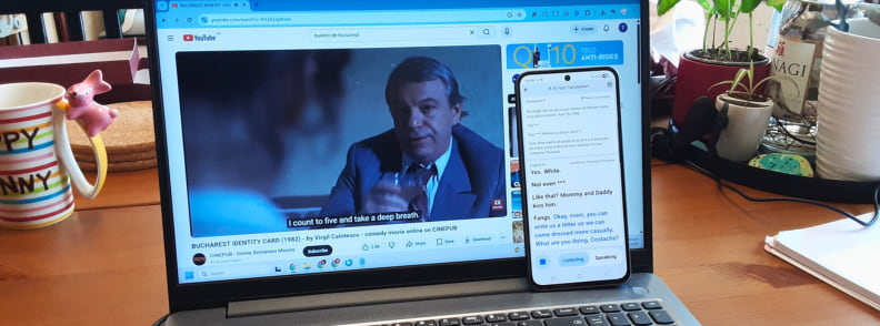 Timekettle W4 AI Interpreter Earbuds used for media translation with laptop video and smartphone displaying translated dialogue.
