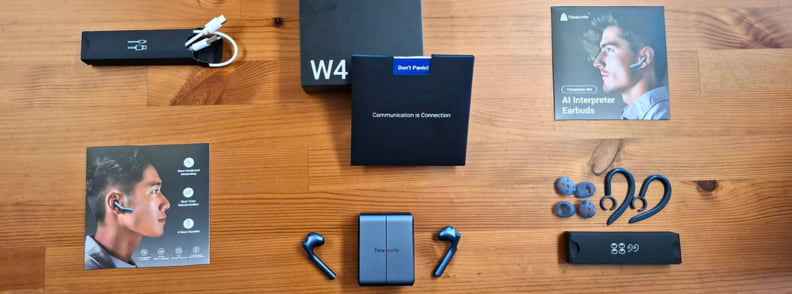 Timekettle W4 AI Interpreter Earbuds full kit with charging case accessories and packaging arranged for travel translation review.