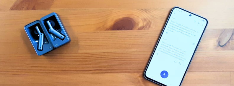 Timekettle W4 AI Interpreter Earbuds next to smartphone showing Google Translate app for translation comparison.