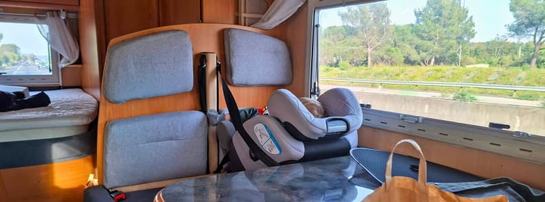 Interior of a campervan with child car seat while traveling to the Foire de Brignoles in Provence.