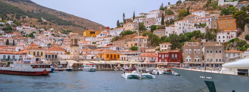 Hydra island Greece harbor with boats and hillside houses during a hydra island day trip from Athens by boat
