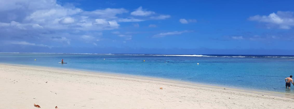 best beaches la reunion safe swimming lagoon beaches Calm lagoon beach in La Réunion with white sand, turquoise water, and protected swimming areas along the west coast.
