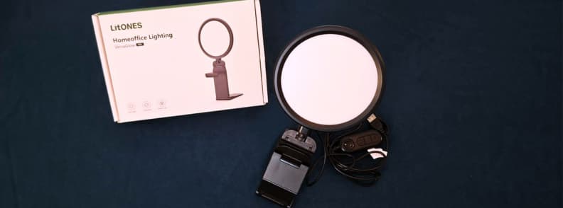 LitONES VersaGlow V01 review setup showing the portable clip-on creator light, USB cable controls, stand, and product box on a dark background.