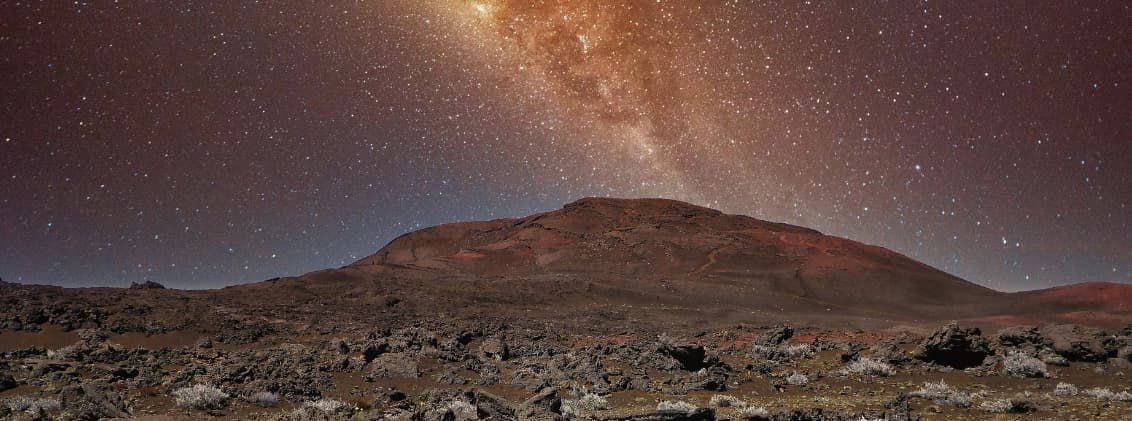 piton de la fournaise hike active volcano la reunion Night view of Piton de la Fournaise in La Réunion, with volcanic terrain under a star-filled sky and the Milky Way above the active volcano.