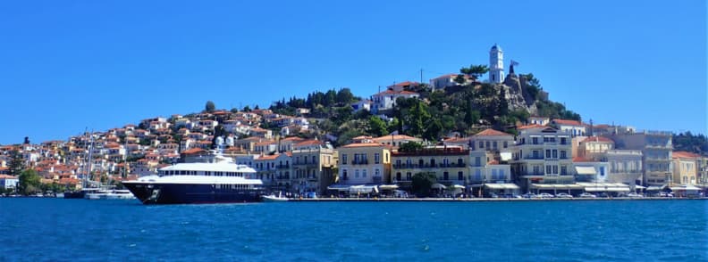Poros Town Greece harbor view with hillside houses and boats during a Poros island day trip from Athens