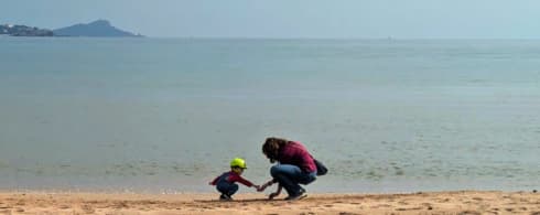 slow travel europe family beach travel the travel bunny mirela letailleur Mirela Letailleur The Travel Bunny and toddler playing on a quiet beach during a slow travel trip in Southern Europe.